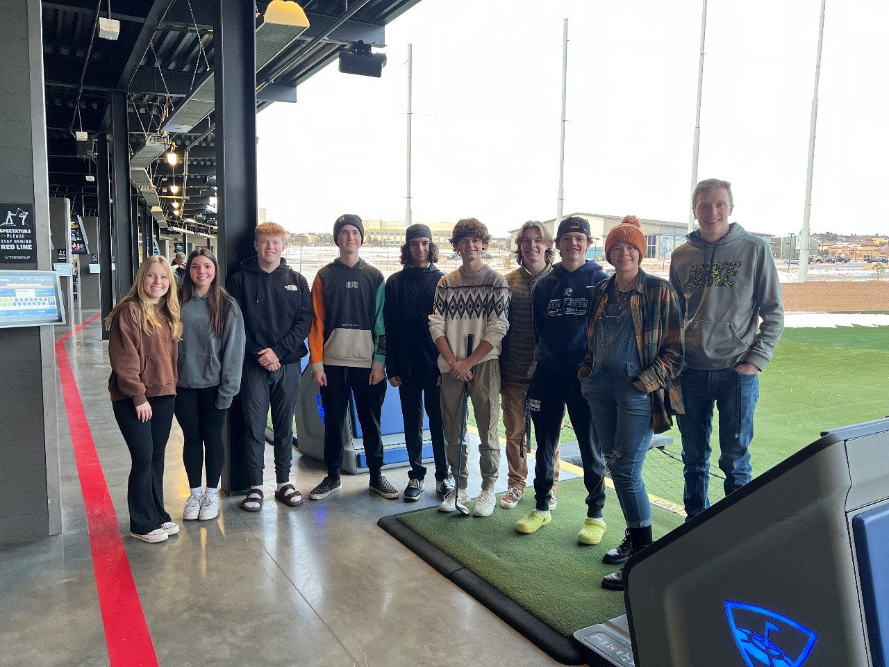 Students pose for a photo at TopGolf.